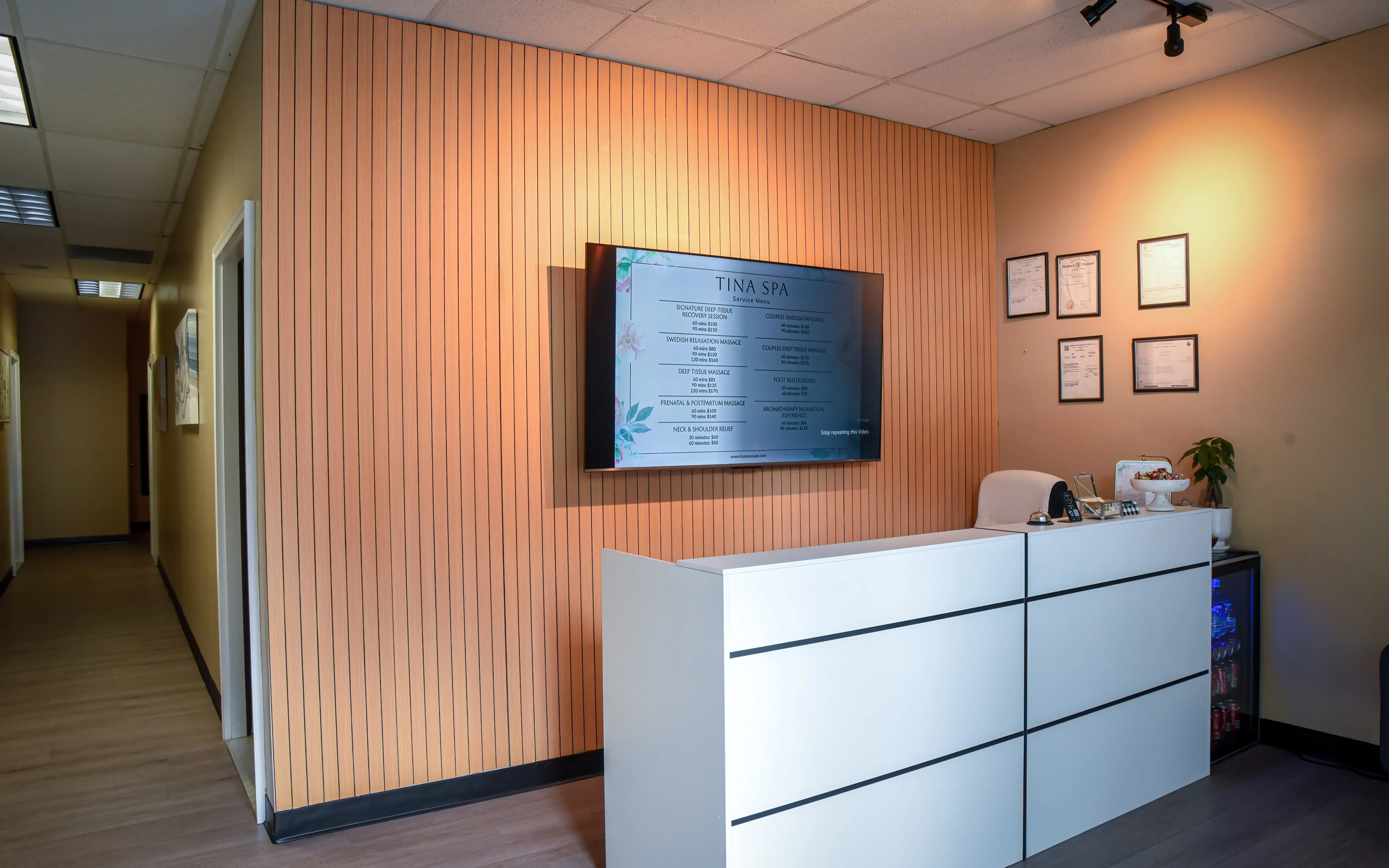 Reception at Tina Spa in Bellevue, Washington, with the front desk and massage service and price board