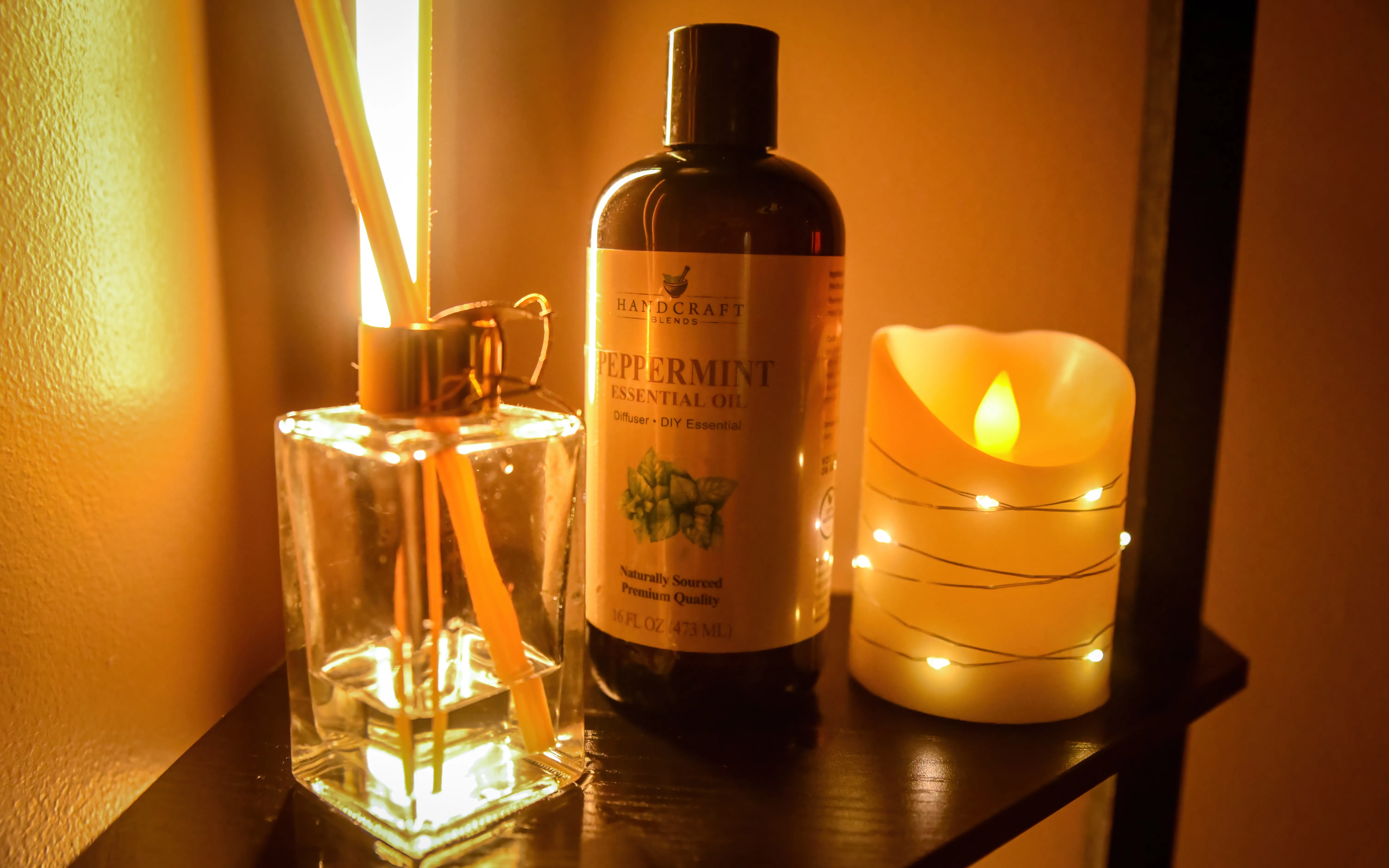 Peppermint essential oil, reed diffuser and candle used for aromatherapy massage at Tina Spa